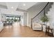 This expansive living area features hardwood floors, recessed lighting, and access to the outdoors at 5310 Craftsman Dr, Parker, CO 80134