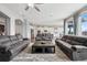 Bright, open living room featuring a large window, wood floors and comfortable sofas at 5310 Craftsman Dr, Parker, CO 80134