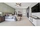 Spacious main bedroom with a stone fireplace, paneled accent wall, and neutral furnishings at 5310 Craftsman Dr, Parker, CO 80134