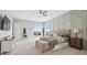 Bright and spacious bedroom with panel accent wall, a large window, and soft carpet at 5310 Craftsman Dr, Parker, CO 80134
