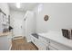 Mudroom with built in shelving, cabinet, coat rack, bench and hooks near front door at 5310 Craftsman Dr, Parker, CO 80134