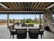 Covered patio with outdoor seating and views of the lush backyard at 5310 Craftsman Dr, Parker, CO 80134