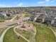 An aerial view shows a vibrant community with walking paths, playground, and green spaces for outdoor enjoyment at 5166 Trails Edge Ln, Castle Rock, CO 80104