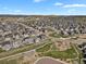 An aerial view of a neighborhood with sidewalks, a playground and beautiful landscaping at 5166 Trails Edge Ln, Castle Rock, CO 80104