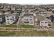 Aerial view of a well-maintained backyard, featuring a deck, patio, and lush green lawn perfect for outdoor activities at 5166 Trails Edge Ln, Castle Rock, CO 80104