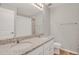 Bathroom featuring a double sink vanity with granite countertop, tile flooring, and modern fixtures at 5166 Trails Edge Ln, Castle Rock, CO 80104