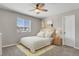 Cozy bedroom with a neutral palette, ceiling fan, and a window providing natural light and neighborhood scenery at 5166 Trails Edge Ln, Castle Rock, CO 80104