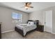 Cozy bedroom with a large window, plush carpet, ceiling fan, and comfortable furnishings at 5166 Trails Edge Ln, Castle Rock, CO 80104