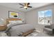 Stylized bedroom with a modern bed, patterned rug, and large window offering neighborhood views at 5166 Trails Edge Ln, Castle Rock, CO 80104