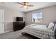 Bedroom with neutral decor, carpeted floor, ceiling fan, dresser, and a window with neighborhood views at 5166 Trails Edge Ln, Castle Rock, CO 80104