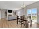 Open concept dining room with a view to the exterior deck and adjacent living room at 5166 Trails Edge Ln, Castle Rock, CO 80104