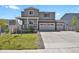 Charming two-story home with a well-maintained lawn and a three-car garage at 5166 Trails Edge Ln, Castle Rock, CO 80104