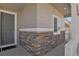 Inviting front porch with stone accents and a stylish gray front door at 5166 Trails Edge Ln, Castle Rock, CO 80104