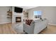 Cozy living room features a fireplace, floating shelves and lots of natural light at 5166 Trails Edge Ln, Castle Rock, CO 80104