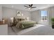 Spacious main bedroom featuring a comfortable bed, ceiling fan, and a bright window with neighborhood views at 5166 Trails Edge Ln, Castle Rock, CO 80104