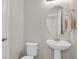 Stylish powder room with pedestal sink and decorative mirror at 5166 Trails Edge Ln, Castle Rock, CO 80104
