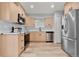 Newly remodeled kitchen with stainless steel appliances and light wood cabinets at 1250 S Monaco Pkwy # 61, Denver, CO 80224