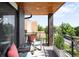 Charming balcony with wood ceiling, exposed beam, brick accent wall, and comfortable outdoor seating at 3617 Shoshone St, Denver, CO 80211