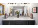 Bright bathroom with a double sink vanity, decorative mirrors, and modern fixtures at 3617 Shoshone St, Denver, CO 80211