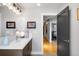 Stylish bathroom boasts a modern vanity with sleek fixtures and a well-lit mirror with decorative artwork at 3617 Shoshone St, Denver, CO 80211