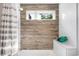Elegant bathroom featuring wood-style tile and glass accents at 3617 Shoshone St, Denver, CO 80211