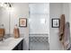 Modern bathroom boasts a sleek vanity, decorative backsplash, and a glass-enclosed shower with stylish tile work at 3617 Shoshone St, Denver, CO 80211