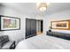 Comfortable bedroom features a cozy bed, elegant artwork, closet doors, and classic furnishings for a relaxing retreat at 3617 Shoshone St, Denver, CO 80211