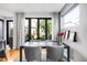 A formal dining room with a view to the outdoor patio area, adjacent to a window with natural light at 3617 Shoshone St, Denver, CO 80211