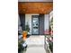 Modern home with a stylish light blue front door, brick accents, and contemporary landscaping at 3617 Shoshone St, Denver, CO 80211