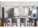 Modern kitchen featuring a large island with seating, sleek cabinetry, and stainless steel appliances at 3617 Shoshone St, Denver, CO 80211