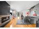Spacious living room with a fireplace, hardwood floors, and an open layout to the kitchen and dining area at 3617 Shoshone St, Denver, CO 80211