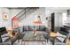 Cozy living room with a comfortable couch, modern decor, and a view into the kitchen at 3617 Shoshone St, Denver, CO 80211