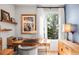 Bright home office with light wood furnishings, desk, and a large window letting in natural light at 3617 Shoshone St, Denver, CO 80211