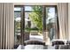 View of outdoor patio and backyard through dining room doors featuring patio furniture and fire pit at 3617 Shoshone St, Denver, CO 80211