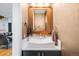 Stylish powder room featuring a modern vessel sink, decorative mirror, and textured wall finish at 3617 Shoshone St, Denver, CO 80211