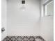 Modern shower features sleek white tile, decorative mosaic tile accents, a rainfall showerhead, and a built-in bench at 3617 Shoshone St, Denver, CO 80211