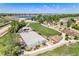 Aerial view of a community park with a lake, basketball court, community garden, and green space at 9530 E 113Th Ave, Commerce City, CO 80640