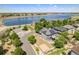 Aerial view of home with solar panels, a fenced yard, and a lake view in a tranquil neighborhood at 9530 E 113Th Ave, Commerce City, CO 80640