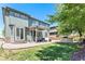 Landscaped backyard with a grass lawn, brick patio, wooden pergola, and built-in grill, perfect for outdoor living at 9530 E 113Th Ave, Commerce City, CO 80640