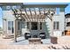 Backyard patio area with a fire pit and outdoor seating under a charming pergola near sliding glass doors at 9530 E 113Th Ave, Commerce City, CO 80640