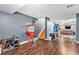 Recreational basement space with wooden floors, stairs, and a vintage popcorn machine at 9530 E 113Th Ave, Commerce City, CO 80640