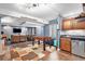 Finished basement space with a kitchenette, foosball table, and cozy seating area with a fireplace at 9530 E 113Th Ave, Commerce City, CO 80640