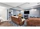 Basement living room with a fireplace, large-screen TV, and comfortable reclining furniture at 9530 E 113Th Ave, Commerce City, CO 80640