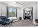 Comfortable bedroom with a seating area, large window, and neutral color scheme at 9530 E 113Th Ave, Commerce City, CO 80640