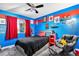 Vibrant bedroom featuring unique wall art and a cozy gray chair at 9530 E 113Th Ave, Commerce City, CO 80640