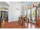 Dining area with hardwood floors, adjacent to an open archway and large windows with natural light at 9530 E 113Th Ave, Commerce City, CO 80640