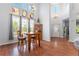 Dining area with hardwood floors, a charming chandelier, high ceilings, and large windows for plenty of natural light at 9530 E 113Th Ave, Commerce City, CO 80640