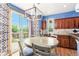 Cozy dining area with a round table and sliding door access to the backyard, perfect for indoor-outdoor living at 9530 E 113Th Ave, Commerce City, CO 80640