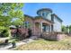 Charming two-story home featuring stone accents, arched entryway, and a well-maintained front yard with mature trees at 9530 E 113Th Ave, Commerce City, CO 80640