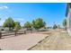 Front yard featuring a gravel area, lawn, fenced perimeter, and a glimpse of the neighboring street at 9530 E 113Th Ave, Commerce City, CO 80640